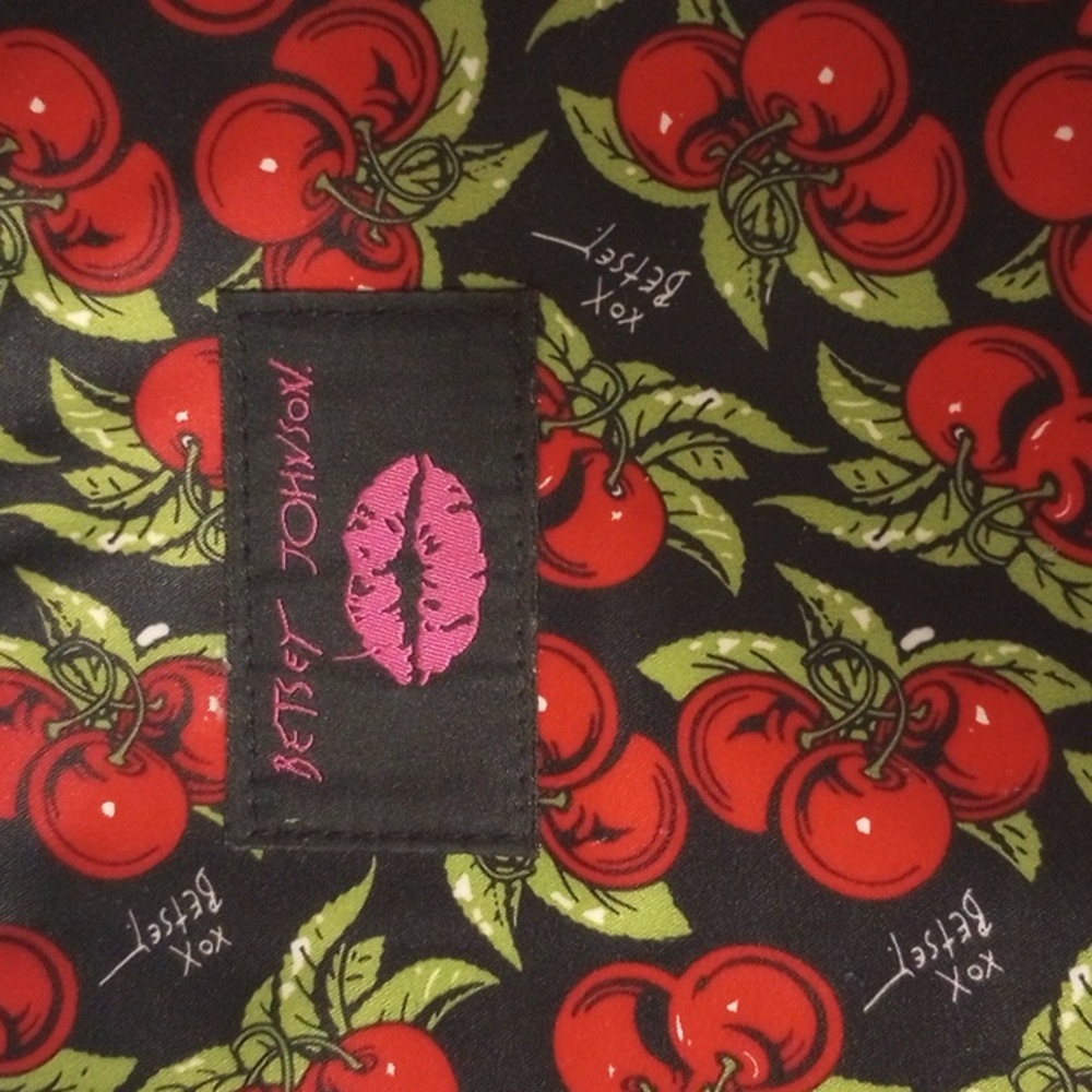 Betsy Johnson computer bag in a cherry print with a black background